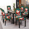 Set of four Santa Claus pattern stretch chair covers displayed on a dining table.