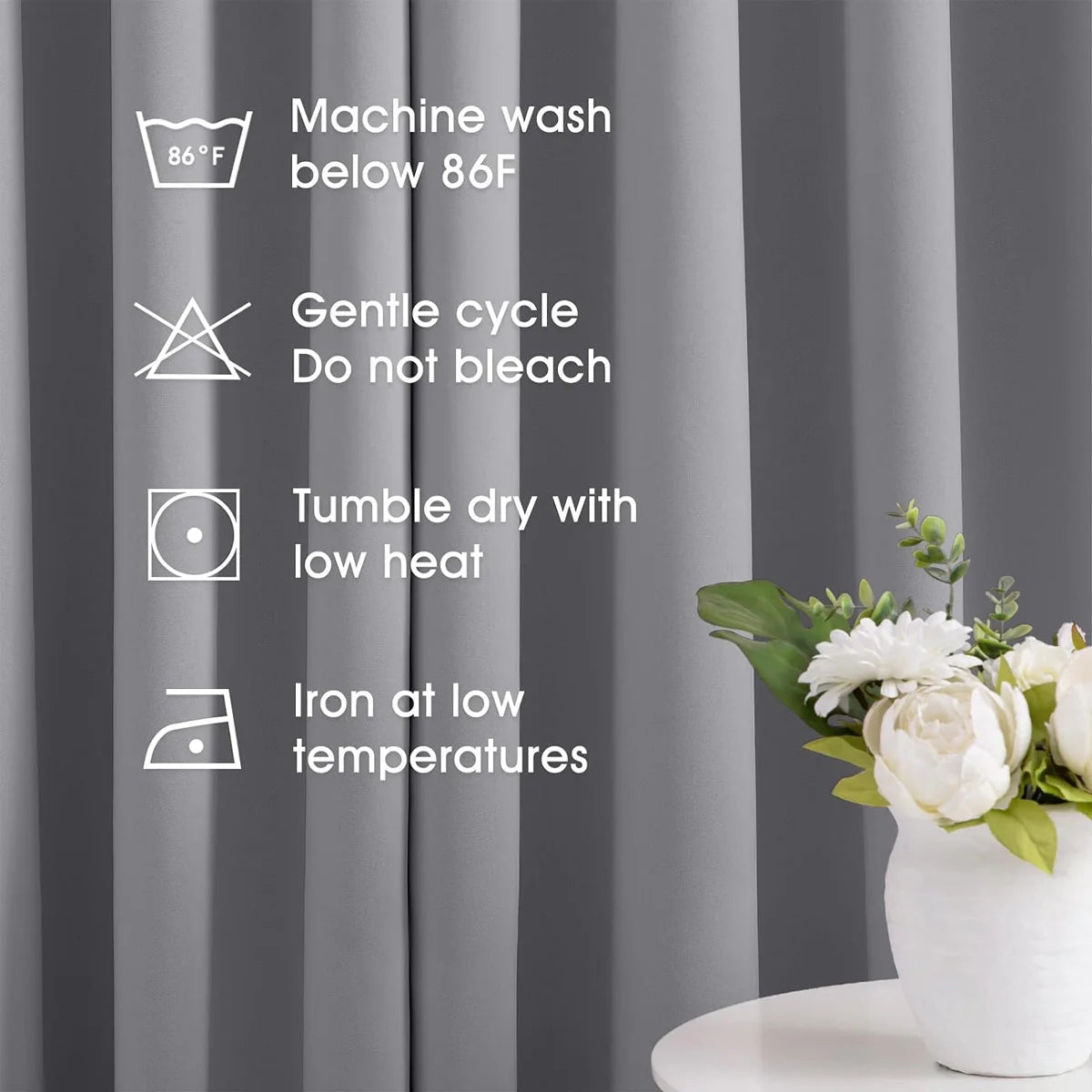 A set of gray blackout curtains with washing and care instructions displayed against a curtain backdrop.