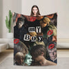 A graphic throw blanket featuring a collage of male characters from a movie, including a prominent face and red lips.