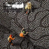 A close-up view of a black, textured mat with white dots, showing an anti-skid bottom feature.