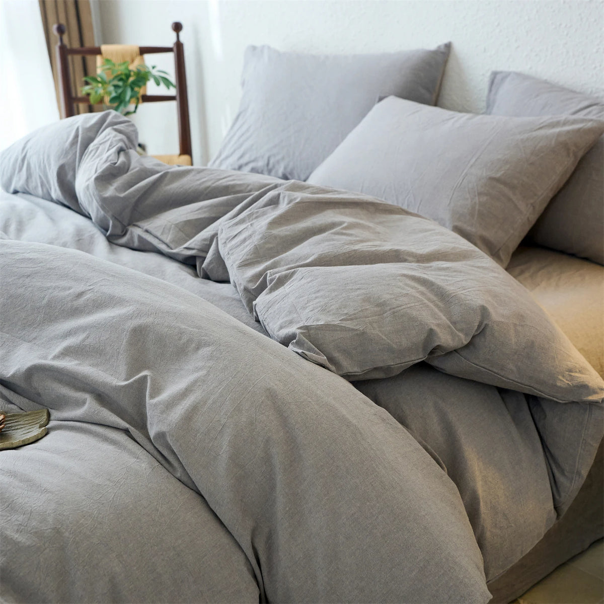 A light gray cotton yarn-dyed duvet cover with matching pillows on a bed.