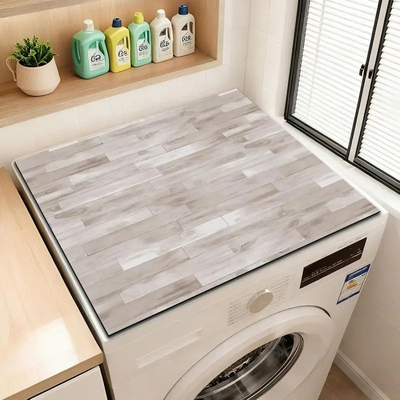 A white wood grain fridge cover mat is displayed inside a white washing machine.
