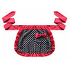 A vibrant pink ruffle apron with black polka dots and a bow, featuring fabric straps.