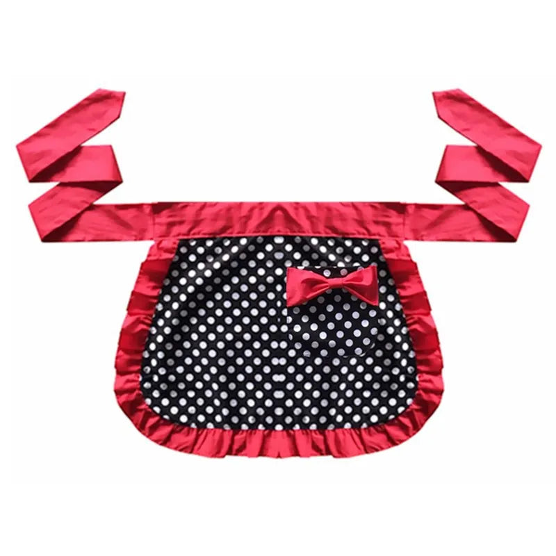 A vibrant pink ruffle apron with black polka dots and a bow, featuring fabric straps.