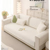 A light beige machine washable anti-slip sofa slipcover displayed in a modern living room setting.