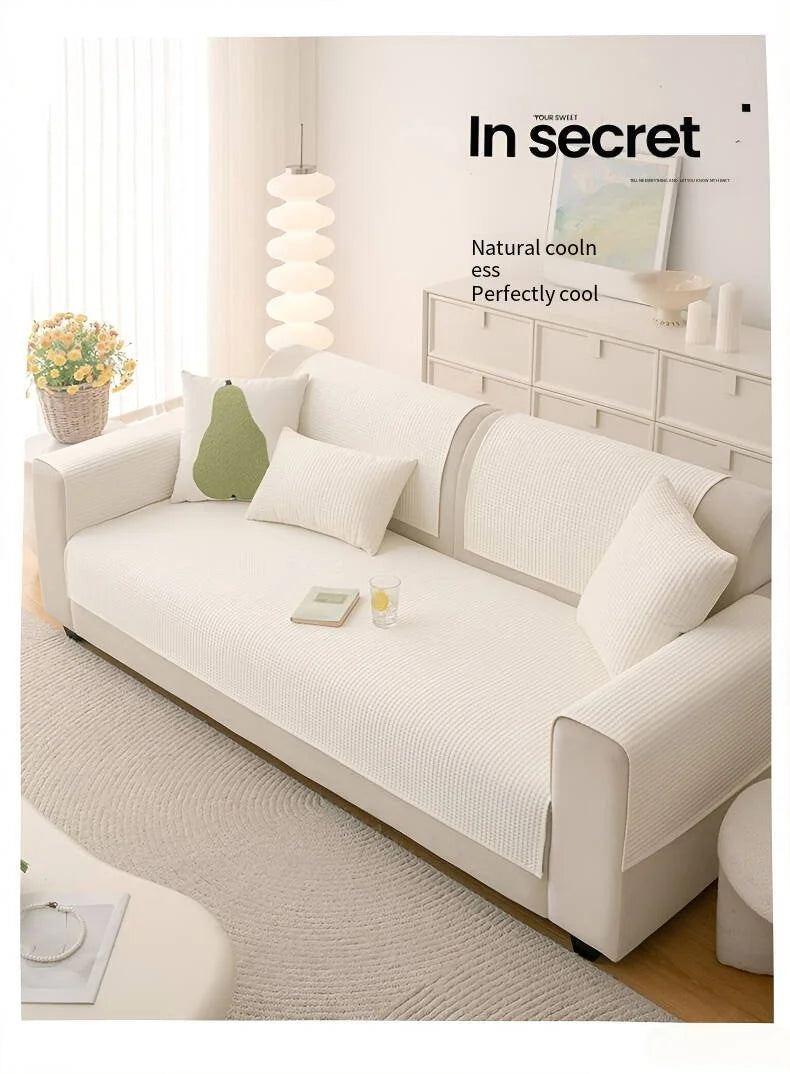 A light beige machine washable anti-slip sofa slipcover displayed in a modern living room setting.