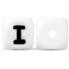 Two white silicone alphabet beads, one showing the letter I and the other blank.