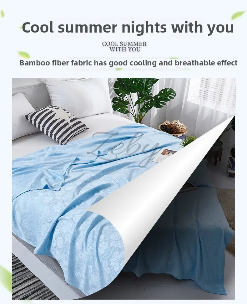 A light blue bamboo fiber blanket is spread on a white bed, showing its breathable fabric texture.