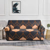 A dark gray sofa covered in a geometric pattern of orange and black lines.