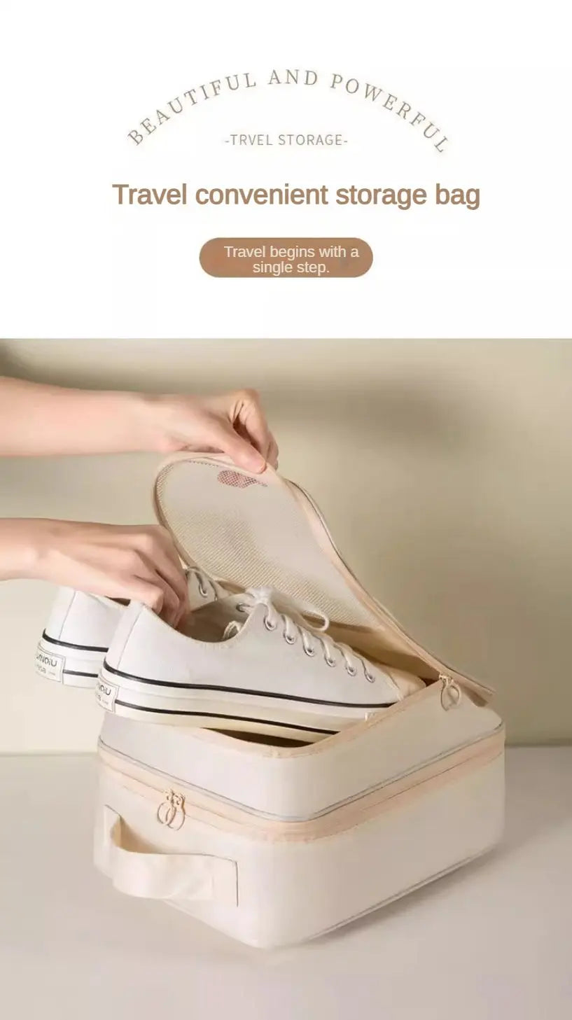 A hand opens a beige portable travel shoe organizer bag revealing a pair of white sneakers inside.