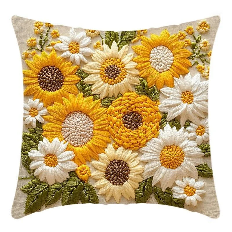 A decorative cushion pillow cover featuring a dense arrangement of yellow and white sunflowers and green foliage.