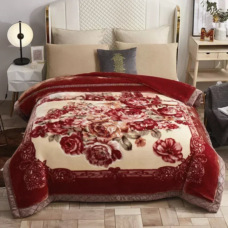 A richly colored red velvet weighted blanket with a floral pattern displayed on a bed.