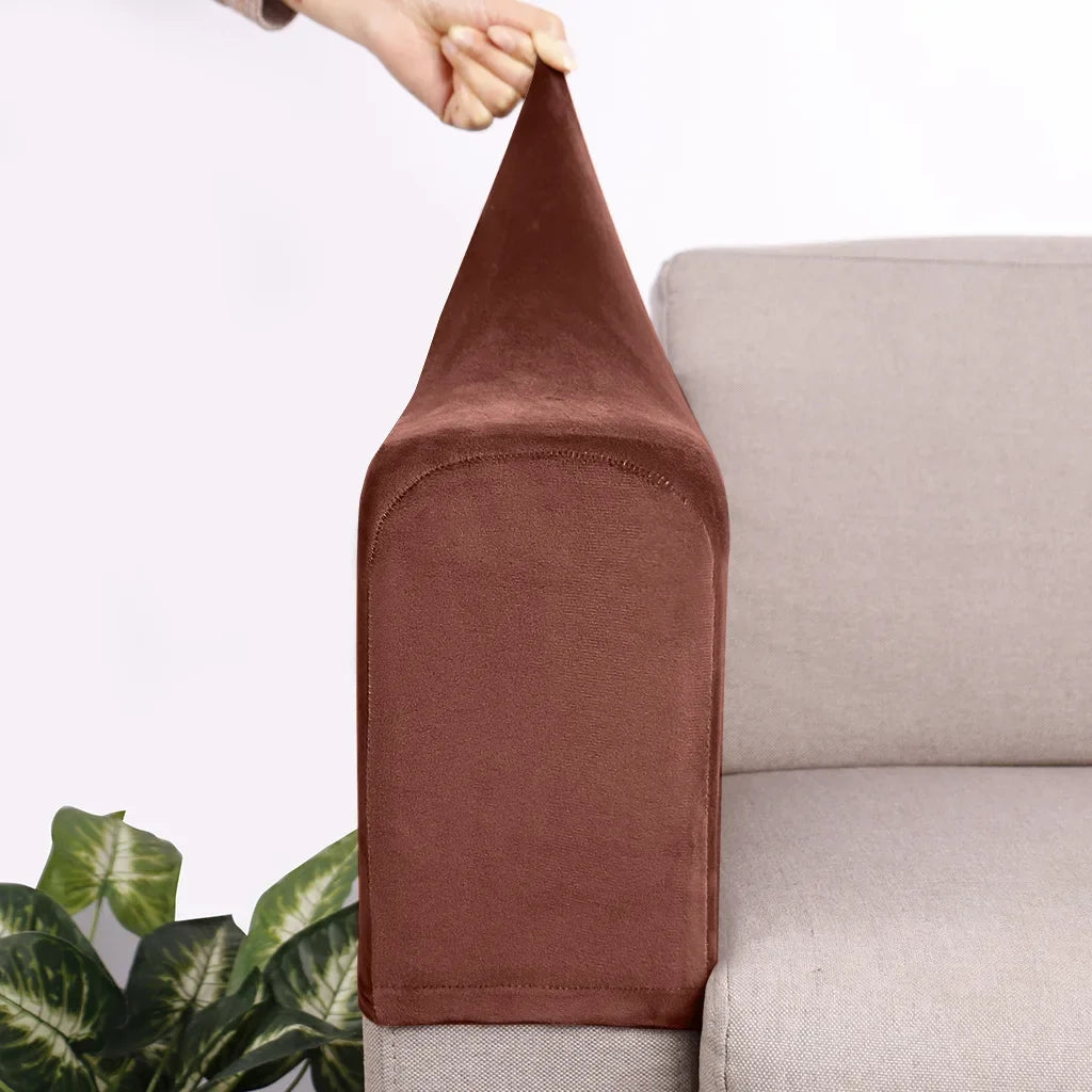 A close-up of a dark brown velvet sofa armrest cover being held by a hand, resting on a light gray sofa.