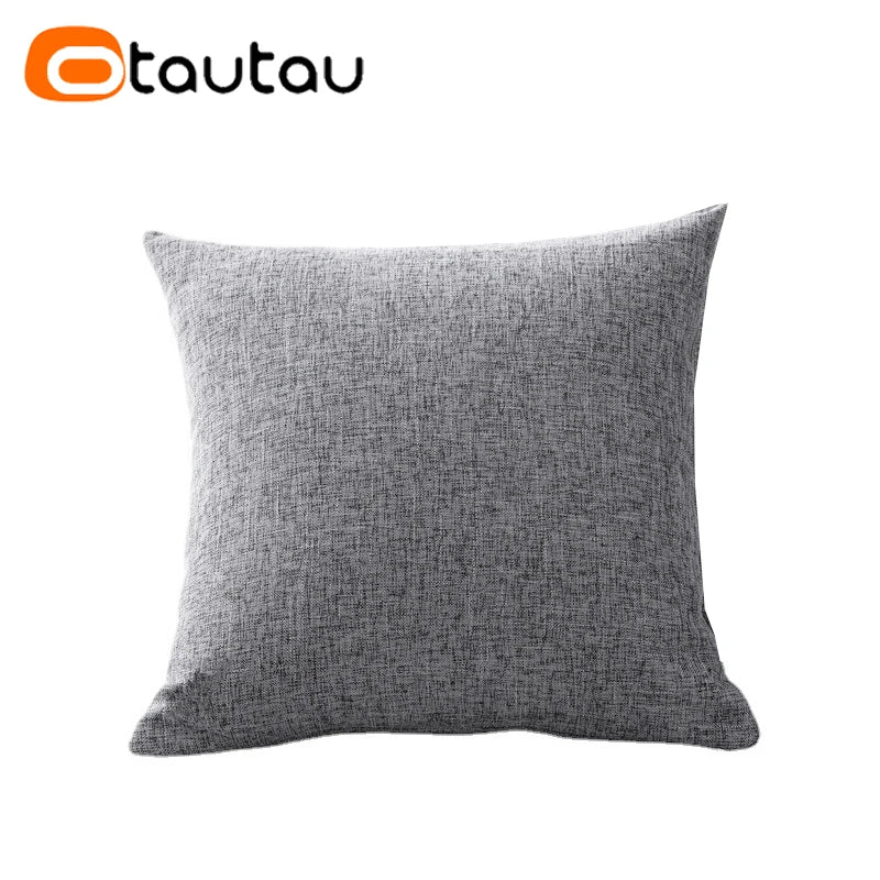 A gray linen cushion cover with a button closure.