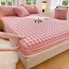 A pink luxury faux rabbit fur fitted sheet set displayed on a bed with white curtains and natural light.