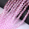 Pink faceted rondelle glass beads strung on black cord for crafting