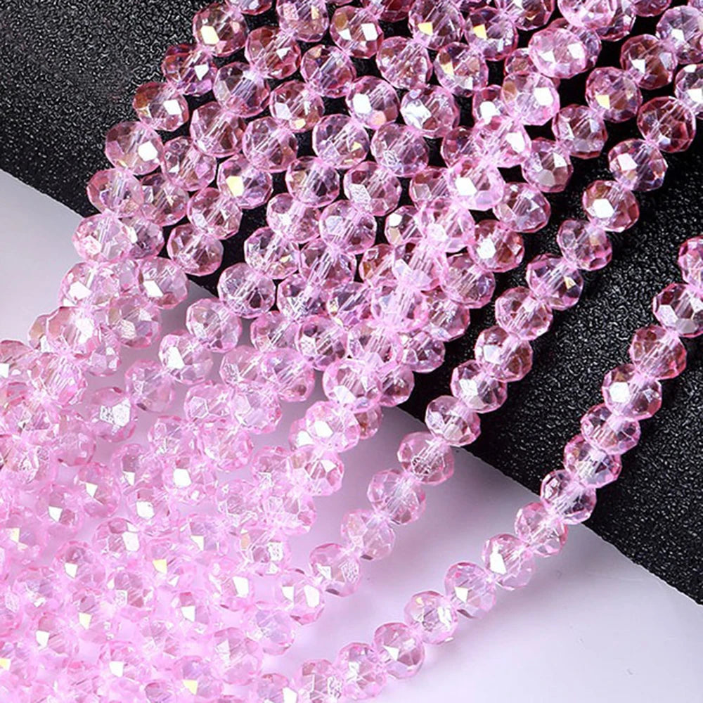 Pink faceted rondelle glass beads strung on black cord for crafting