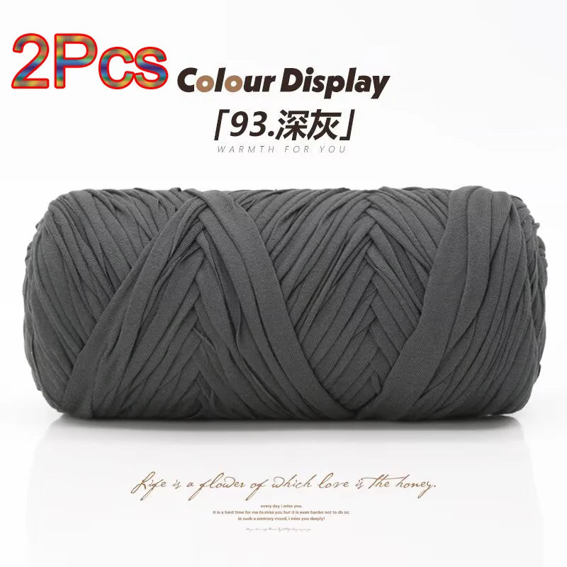 A skein of grey reusable elastic yarn is shown rolled up for crafting.