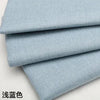 Stack of light blue coarse linen and cotton fabric rolls