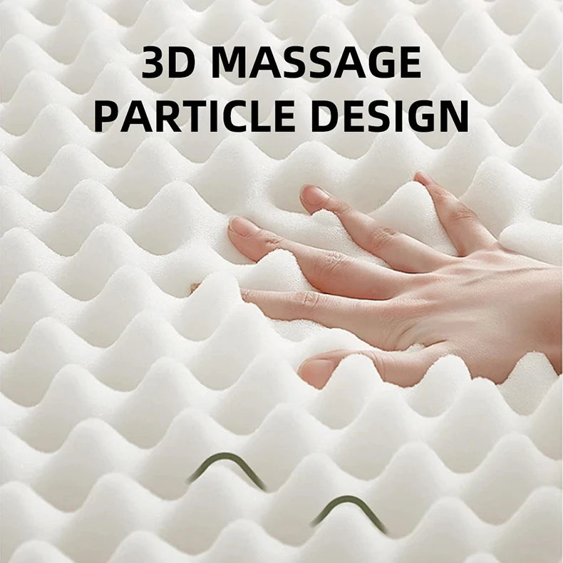 A hand is gently touching a white, textured massage cushion featuring a 3D massage particle design.