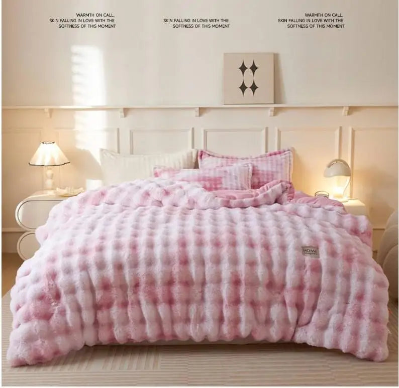 A pink and white plaid plush rabbit quilt comforter displayed on a bed with light wood accents.