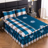 A set of three fitted bed sheets in blue and white plaid with elastic lace trim on a bed.