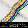 A close-up of multi-color rhinestone cup chains in various shades of yellow, pink, purple, and green arranged diagonally.