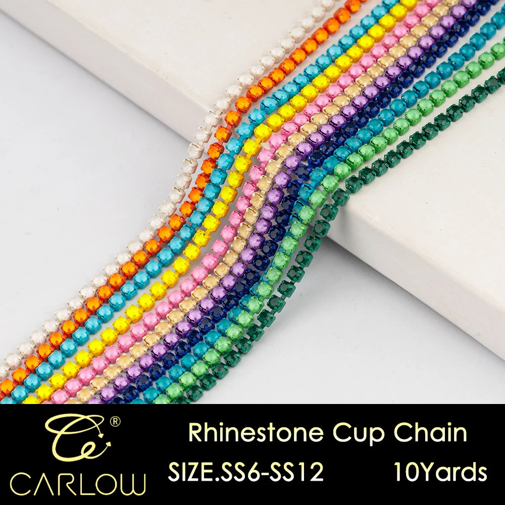 A close-up of multi-color rhinestone cup chains in various shades of yellow, pink, purple, and green arranged diagonally.