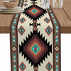 A bohemian linen table runner featuring an Indian-inspired geometric print in shades of brown, teal, and beige.