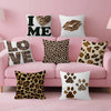 A collection of pink and white decorative pillows featuring leopard print designs, including I ME, LOVE, and paw prints.