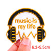 White embroidered patch featuring headphones and the text music is my life on a black background