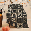 A black and white patchwork throw blanket featuring various spooky Halloween motifs like bats ghosts and pumpkins.
