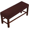 A dark brown upholstered elastic stool cover for living room seating with wooden legs.