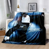A dark blue and black retro printed flannel throw blanket featuring a stylized figure.