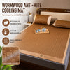 A brown woven anti-mite cooling mat placed on a bed, highlighting botanical ingredients and skin-friendly softness.