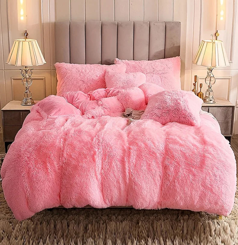 A fluffy pink plush duvet cover set displayed on a bed with neutral bedding and bedside lamps.