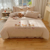 A beige embroidered bedding set featuring cartoon puppies and a lucky and lovely puppy design.