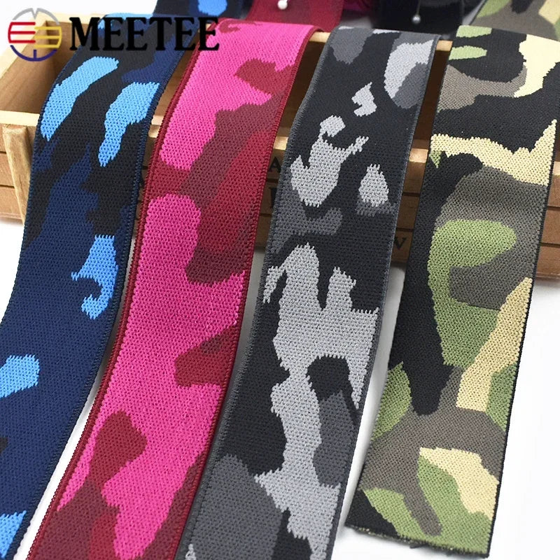 A collection of camouflage colored elastic stretch ribbons for sewing and craft projects.
