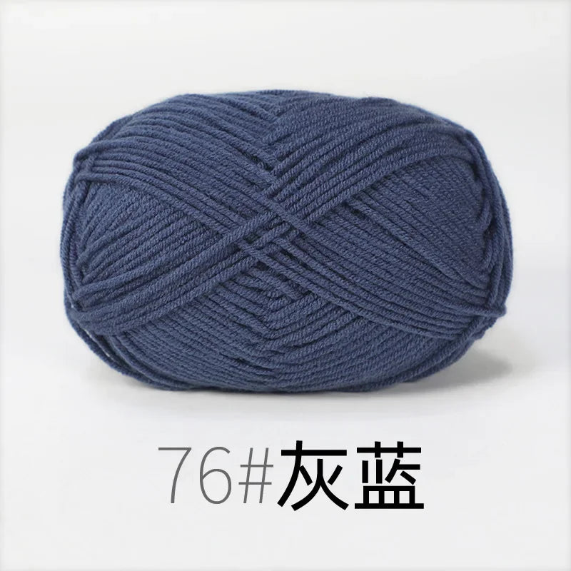 A ball of dark blue organic cotton 4ply knitting yarn for crafts.