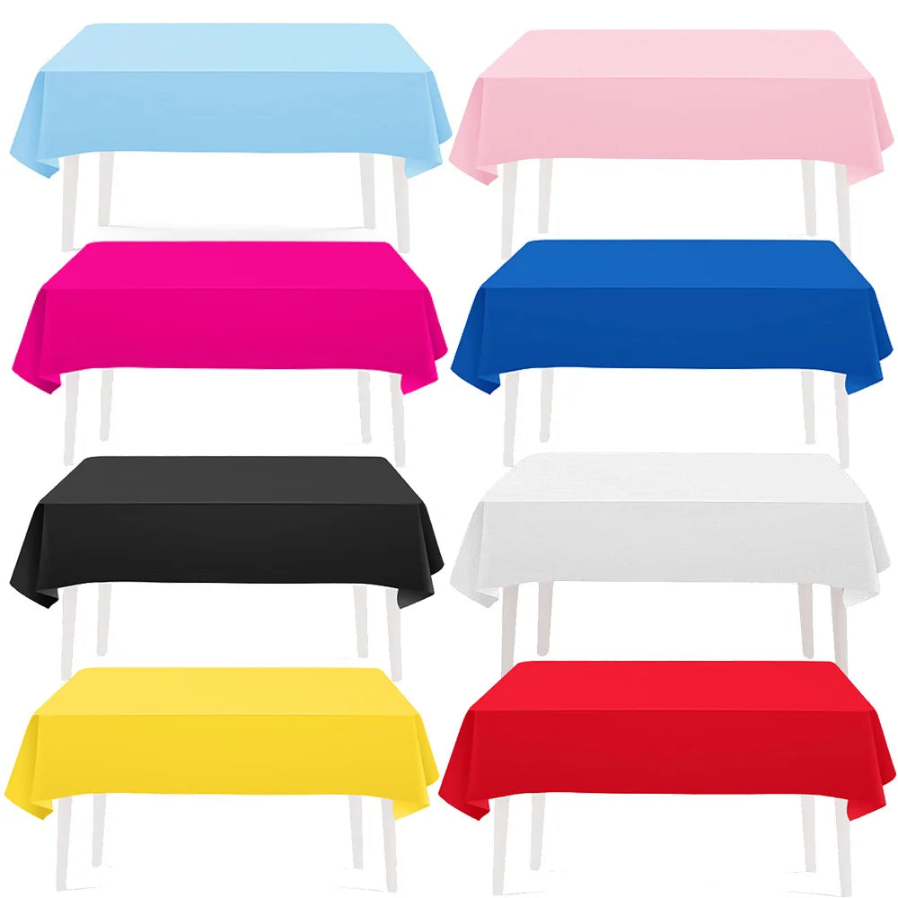 A collection of vibrant solid color rectangle tablecloths in blue, pink, magenta, black, white, and red.