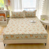A fitted bed sheet with a floral print featuring orange and yellow roses displayed on a white bed frame.