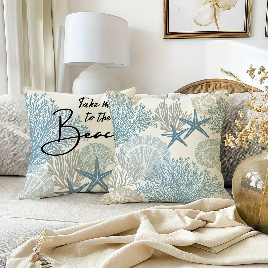 A decorative pillow cover featuring a light blue and white pattern of oceanic coral and starfish on a neutral fabric.