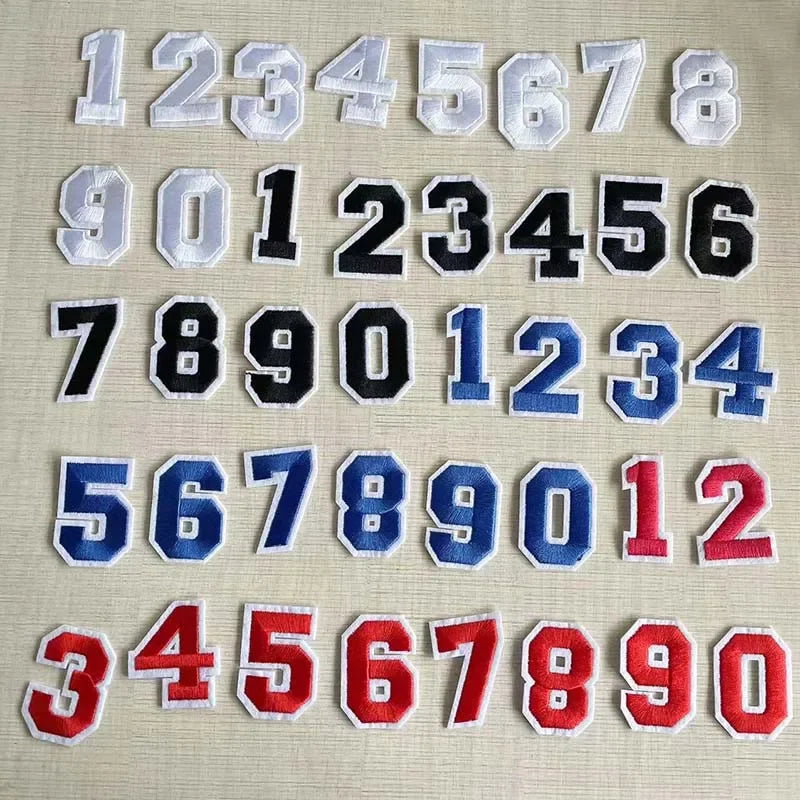 A collection of white, black, and blue number patches for apparel, numbered 1 through 90.