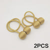 Two gold-toned magnetic ball curtain tiebacks with thin cord.