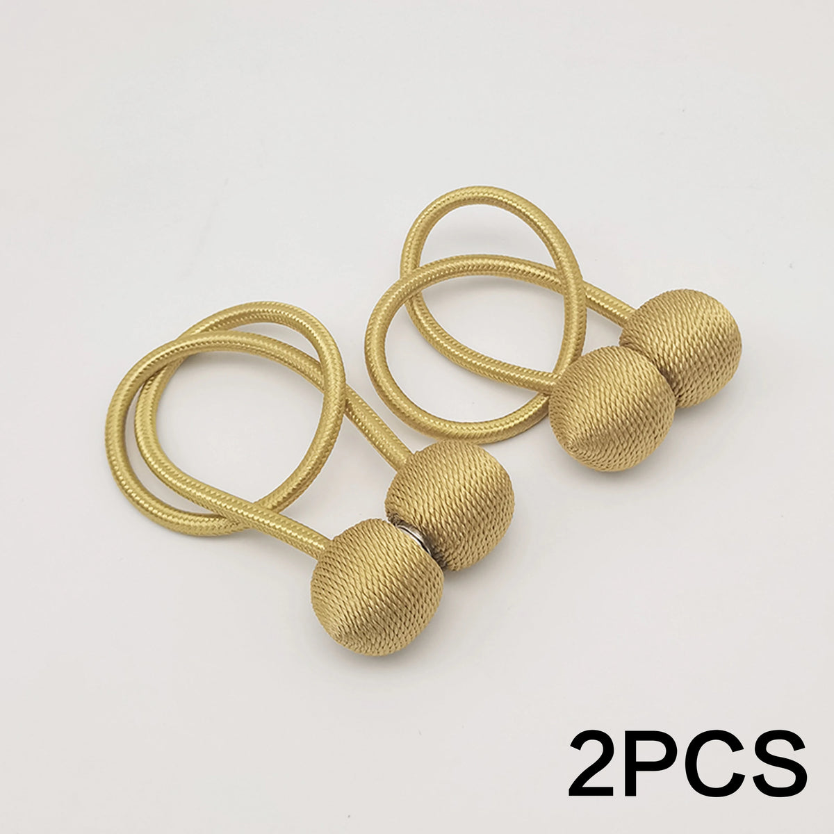 Two gold-toned magnetic ball curtain tiebacks with thin cord.