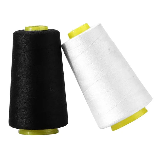 A spool of black polyester sewing thread next to a spool of white polyester sewing thread.