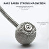 A silver twisted cord magnetic ball with a flat top, demonstrating strong magnetism.