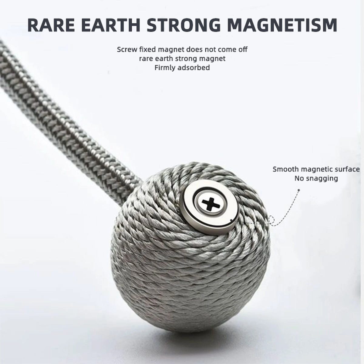 A silver twisted cord magnetic ball with a flat top, demonstrating strong magnetism.