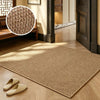 A rectangular beige faux sisal runner rug placed on a light wood floor with indoor plants and wooden furniture visible.