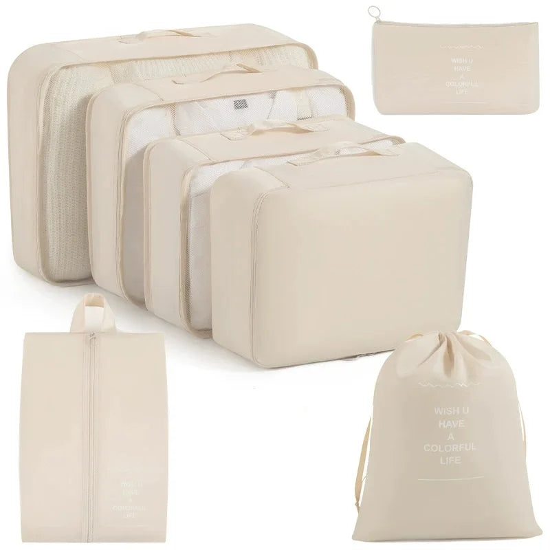 A set of beige travel storage organizers including a large box and smaller pouches.
